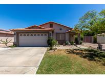 Charming single-story home with a well-manicured lawn and a two car garage and a terracotta tile roof at 7403 W Montebello Ave, Glendale, AZ 85303