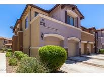 Inviting townhouse featuring a two-car garage, manicured shrubs, and modern architectural details at 7726 E Baseline Rd # 125, Mesa, AZ 85209