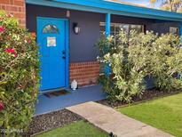 Inviting home exterior featuring a vibrant blue front door and well-manicured landscaping at 846 E Ocotillo Rd, Phoenix, AZ 85014