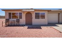 Charming single-story home with a simple front exterior and gravel landscaping at 10018 N 97Th Dr # A, Peoria, AZ 85345