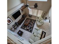 Bright living room with a ceiling fan, tile flooring, and multiple recliner sofas provides comfort at 1032 E Sheffield Ave, Chandler, AZ 85225