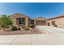 Charming single-story home featuring a well-manicured front yard with desert landscaping and a spacious two-car garage at 10412 W Cottontail Ln, Peoria, AZ 85383