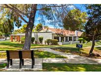 A charming property showcasing a well-kept front lawn and inviting walkway at 156 Leisure World --, Mesa, AZ 85206