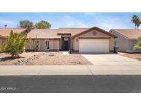 Single story home featuring a terracotta roof, desert landscaping, neutral paint, and two car garage at 16417 S 43Rd Pl, Phoenix, AZ 85048