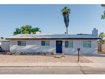 Charming single-story home with a xeriscaped front yard and blue front door at 217 E Bruce Ave, Gilbert, AZ 85234