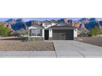Charming single-story home with a two-car garage, desert landscaping, and mountain views at 24254 W Hacienda Ave, Buckeye, AZ 85326