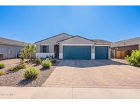 Charming single-story home with a three car garage and beautifully landscaped front yard at 32729 N Mach Ln, San Tan Valley, AZ 85143