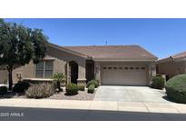Charming single-story home with a well-manicured front yard and a two-car garage at 4528 E Donato Dr, Gilbert, AZ 85298
