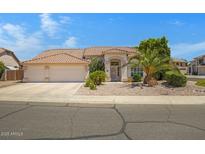 Charming single-story home featuring a spacious garage, desert landscaping, and a welcoming entrance at 592 W Harvard Ave, Gilbert, AZ 85233