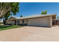 Charming single-story home with a two-car garage and spacious driveway, perfect for suburban living at 8315 E Vernon Ave, Scottsdale, AZ 85257