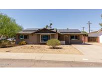 Charming single-story home with a well-maintained front yard and solar panels on the roof at 8532 E Sheridan St, Scottsdale, AZ 85257