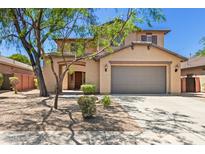 Charming two-story home with a well-manicured front yard and covered entryway at 9051 W Iona Way, Peoria, AZ 85383