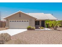 Charming single-story home with a two-car garage, desert landscaping and a light tile roof at 1063 W Vaughn St, Tempe, AZ 85283