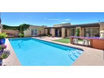 The long, sparkling backyard pool offers a refreshing escape, with a built-in barbecue nearby for outdoor entertaining at 1131 N Cherry --, Mesa, AZ 85201