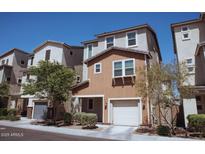 Charming townhome with a two-car garage and well-maintained landscaping at 1183 S Tumbleweed Ln, Chandler, AZ 85286