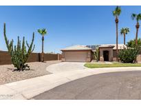 Charming single-story home with a tile roof, desert landscaping, and a circular driveway at 16288 W Hadley St, Goodyear, AZ 85338