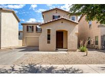 Charming two-story home featuring a gravel front yard, covered porch, and attached garage at 21182 E Stonecrest Dr, Queen Creek, AZ 85142