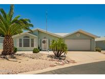 Charming single-story home with a two-car garage and desert landscaping at 215 N Power Rd # 21, Mesa, AZ 85205