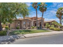 Beautiful single-Gathering home featuring a manicured lawn, desert landscaping, and a stunning stone facade at 4327 E Capricorn Pl, Chandler, AZ 85249