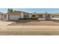 Charming single-story home featuring a low-maintenance desert landscape and attached two-car garage at 4419 W Vogel Ave, Glendale, AZ 85302