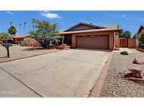 Charming single-story home with a brick exterior and well-maintained desert landscaping, plus a large driveway at 4509 E Joan De Arc Ave, Phoenix, AZ 85032