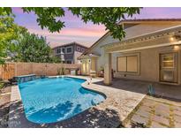 Inviting backyard pool with waterfall feature and lush landscaping at 45131 W Horse Mesa Rd, Maricopa, AZ 85139