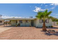 Charming single-story home with desert landscaping, a palm tree, and a covered parking area at 5309 E Butte St, Mesa, AZ 85205