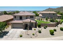 Charming two-story home showcasing landscaped front yard and well-manicured lawn with a pool at 6712 W Miner Trl, Peoria, AZ 85383