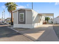 Charming manufactured home with covered parking and well maintained exterior and mature trees at 701 S Dobson Rd # 203, Mesa, AZ 85202