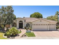 Attractive single-story home showcasing a three-car garage, tile roof, landscaped yard, and welcoming front entry at 7032 N 2Nd Ave, Phoenix, AZ 85021