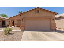 Charming single-story home with a two-car garage and low-maintenance desert landscaping at 716 E Horizon Heights Dr, San Tan Valley, AZ 85143