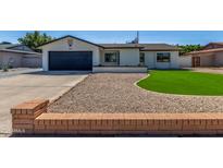 Charming single-story home with well-maintained lawn, desert landscaping, and attached two car garage at 8602 N 42Nd Dr, Phoenix, AZ 85051