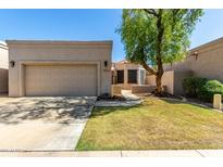 Charming single Gathering home featuring a two-car garage and manicured lawn at 8725 E Vía Del Arbor --, Scottsdale, AZ 85258