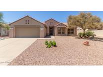 Charming single-story home featuring a desert-landscaped front yard, two-car garage, and a well-maintained facade at 15874 W Wildflower Dr, Surprise, AZ 85374