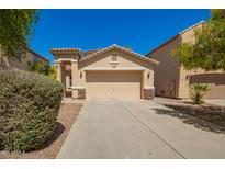 Charming single-story home featuring a two-car garage, desert landscaping, and a welcoming facade at 17493 N Costa Brava Ave, Maricopa, AZ 85139