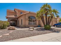 Charming home featuring a well-maintained front yard with desert landscaping and a prominent palm tree at 1751 W Mulberry Dr, Chandler, AZ 85286