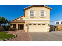 Inviting two-story home featuring a manicured lawn, charming front porch, and attached two-car garage at 1918 E Megan St, Gilbert, AZ 85295