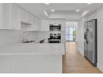 A kitchen featuring white cabinetry, stainless steel appliances and a bright, modern design at 220 N 22Nd Pl # 2036, Mesa, AZ 85213
