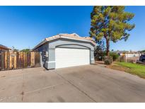 View of the home's two-car garage and spacious driveway with plenty of parking space at 403 N Monte Vista St, Chandler, AZ 85225