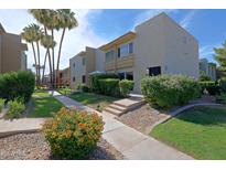 Charming condo exterior featuring a well-maintained lawn and lush landscaping at 4600 N 68Th St # 351, Scottsdale, AZ 85251