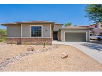 Charming single story home with stone accents, desert landscaping, and attached two car garage at 5434 W T Ryan Ln, Laveen, AZ 85339