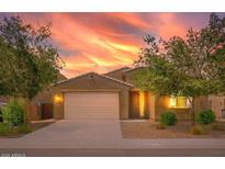 Charming single-Gathering home boasting a two-car garage, desert landscaping and a beautiful Arizona sunset at 626 W Tallula Trl, San Tan Valley, AZ 85140