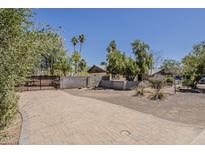 Charming home with desert landscaping, gated entry and brick driveway, providing curb appeal at 6302 E Turquoise Ave, Paradise Valley, AZ 85253