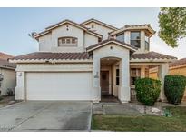 Charming two-story home featuring a white stucco exterior, a tile roof, and a well-maintained front yard with mature landscaping at 6846 S 26Th Pl, Phoenix, AZ 85042