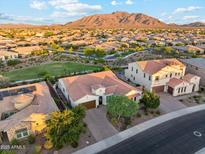 Stunning aerial view of home, showcasing the tile roof, landscaped yard, and mountain views at 7511 S Parkcrest St, Gilbert, AZ 85298
