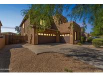 Two-story stucco home with brown garage doors, a low-maintenance front yard, and desert landscaping at 8503 W Coyote Dr, Peoria, AZ 85383