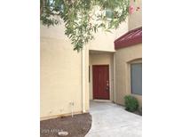 Inviting front entrance features a red door, covered walkway, and desert landscaping at 1015 S Val Vista Dr # 8, Mesa, AZ 85204