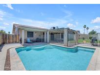 Refreshing in-ground pool with a fenced-in patio area, perfect for outdoor relaxation and entertaining at 12029 N 44Th Dr, Glendale, AZ 85304