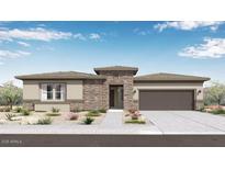 Charming single-story home with desert landscaping, brick accents, and a two-car garage at 14187 W Soft Wind Cir, Surprise, AZ 85387
