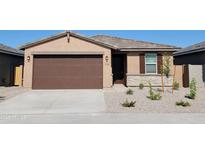 Charming single-story home with a brown garage door, well-maintained landscaping, and stone accents at 19406 N Fiano Dr, Maricopa, AZ 85138
